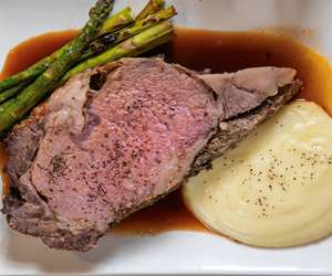 Prime rib with asparagus and mashed potatoes.